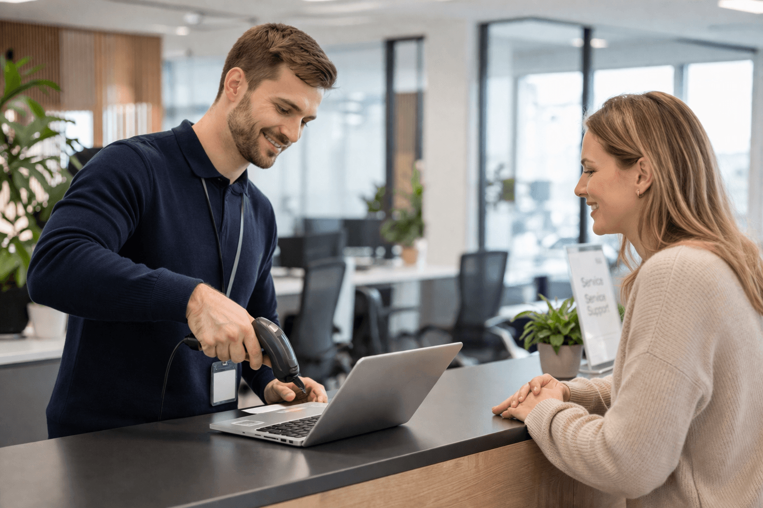 IT technician scanning a device at the helpdesk